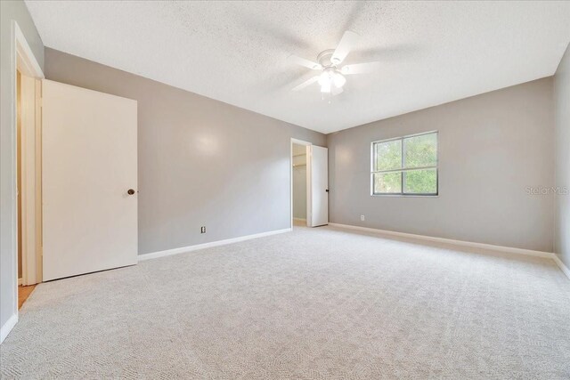 683 Midway Dr Unit B, Ocala, FL 34472 - unfurnished room featuring a ceiling fan, a textured ceiling, and light carpet