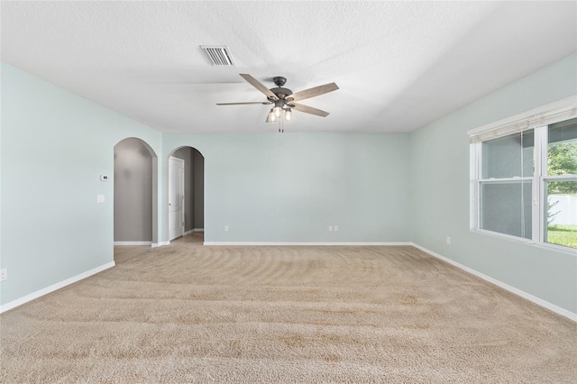 7054 SW 64th Ter, Ocala, FL 34476 - spare room with arched walkways, a ceiling fan, carpet, and a textured ceiling