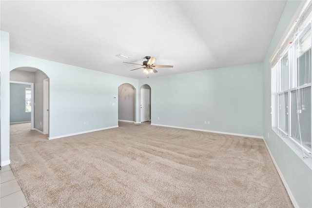7054 SW 64th Ter, Ocala, FL 34476 - spare room featuring a ceiling fan, light carpet, arched walkways, and healthy amount of natural light