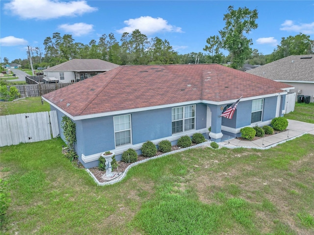 14762 SW 22nd Court Rd, Ocala, FL 34473 - ranch-style home featuring stucco siding, roof with shingles, and a gate