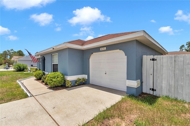 14762 SW 22nd Court Rd, Ocala, FL 34473 - view of front of house featuring a garage, stucco siding, and driveway