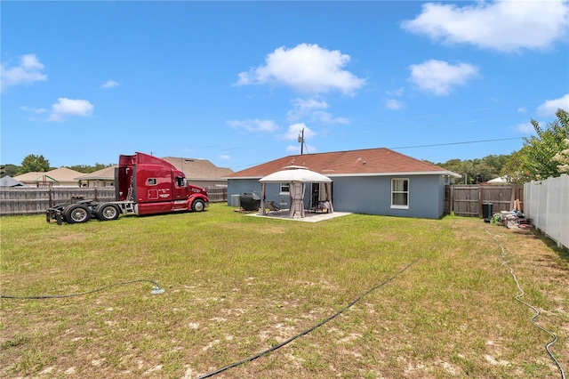 14762 SW 22nd Court Rd, Ocala, FL 34473 - rear view of property featuring a patio, a fenced backyard, a gazebo, and stucco siding