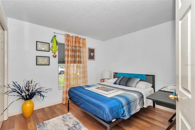 14762 SW 22nd Court Rd, Ocala, FL 34473 - bedroom featuring wood finished floors and a textured ceiling