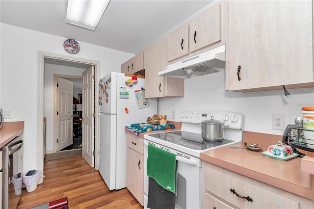 14762 SW 22nd Court Rd, Ocala, FL 34473 - kitchen with white appliances, under cabinet range hood, light countertops, and light wood-style flooring