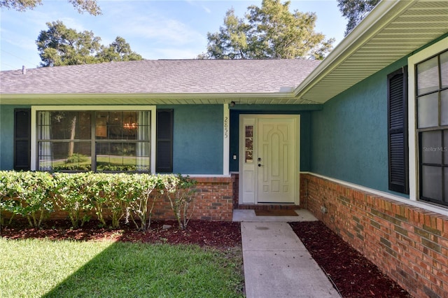 2855 SE 38th St, Ocala, FL 34480 - property entrance with brick siding, stucco siding, and roof with shingles