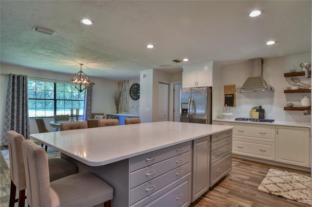 2855 SE 38th St, Ocala, FL 34480 - kitchen featuring appliances with stainless steel finishes, wall chimney exhaust hood, a center island, white cabinetry, and recessed lighting