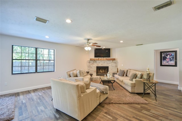 2855 SE 38th St, Ocala, FL 34480 - living room with a ceiling fan, a textured ceiling, a fireplace, wood finished floors, and recessed lighting