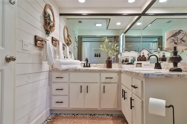 2855 SE 38th St, Ocala, FL 34480 - bathroom featuring double vanity, a shower stall, recessed lighting, and wood walls