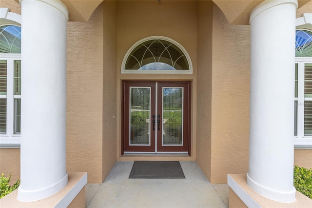 5024 SW 114th Street Rd, Ocala, FL 34476 - property entrance with stucco siding and french doors