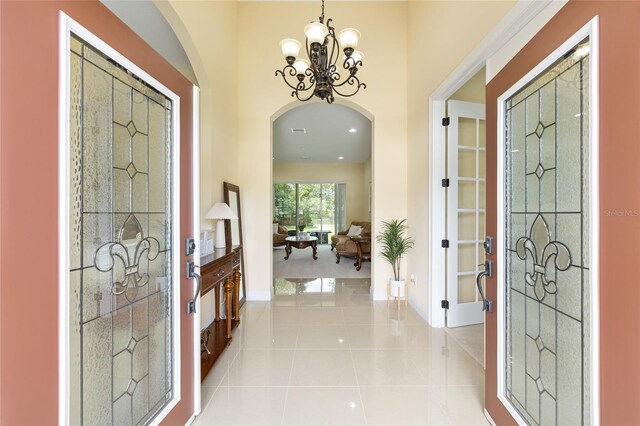 5024 SW 114th Street Rd, Ocala, FL 34476 - tiled entryway with arched walkways and a chandelier