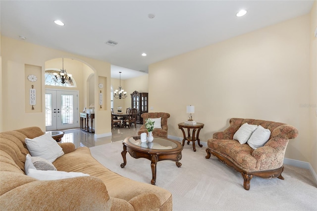 5024 SW 114th Street Rd, Ocala, FL 34476 - living area featuring arched walkways, a chandelier, recessed lighting, french doors, and light carpet