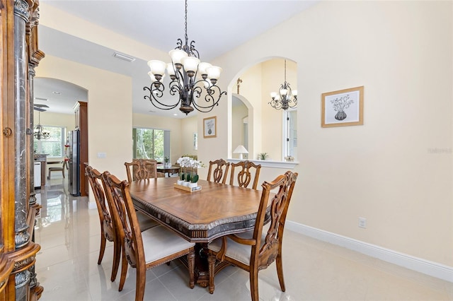 5024 SW 114th Street Rd, Ocala, FL 34476 - dining area with a chandelier, arched walkways, and light tile patterned flooring
