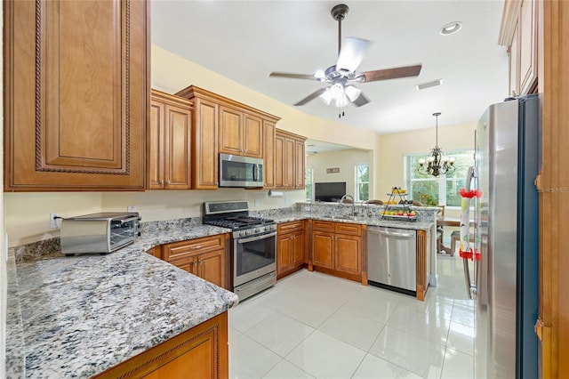 5024 SW 114th Street Rd, Ocala, FL 34476 - kitchen featuring stainless steel appliances, a peninsula, brown cabinetry, a ceiling fan, and recessed lighting