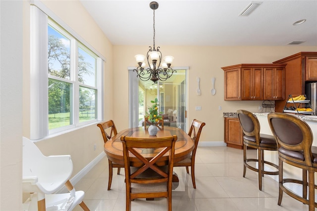 5024 SW 114th Street Rd, Ocala, FL 34476 - dining space featuring a chandelier and light tile patterned floors