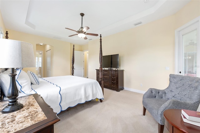 5024 SW 114th Street Rd, Ocala, FL 34476 - bedroom with arched walkways, light carpet, a tray ceiling, and ceiling fan