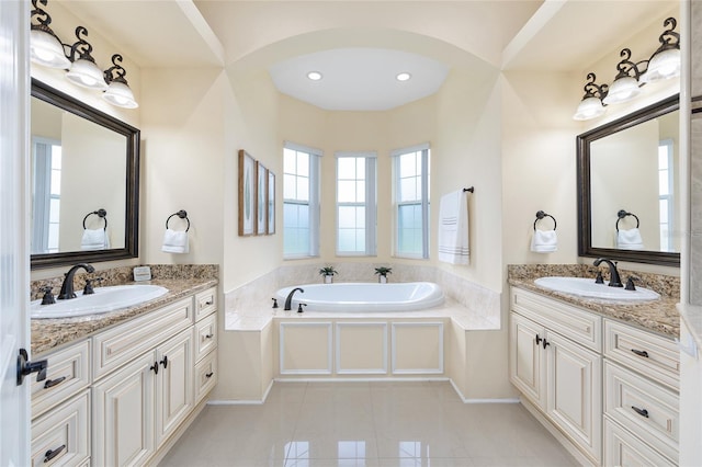 5024 SW 114th Street Rd, Ocala, FL 34476 - full bathroom featuring two vanities, a garden tub, tile patterned flooring, and recessed lighting