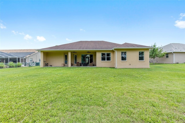 5024 SW 114th Street Rd, Ocala, FL 34476 - back of property featuring a ceiling fan, stucco siding, and a yard
