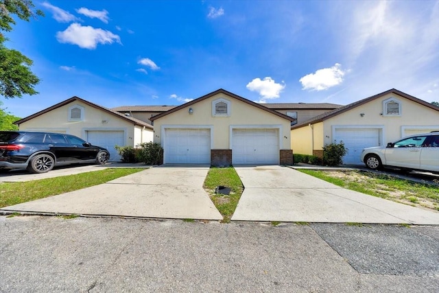 329 Marion Oaks Blvd Unit A3, Ocala, FL 34473 - view of front of property featuring brick siding, a garage, and stucco siding