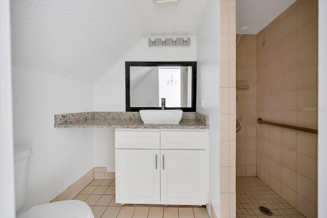 329 Marion Oaks Blvd Unit A3, Ocala, FL 34473 - bathroom with a tile shower, tile patterned floors, vanity, a textured ceiling, and lofted ceiling