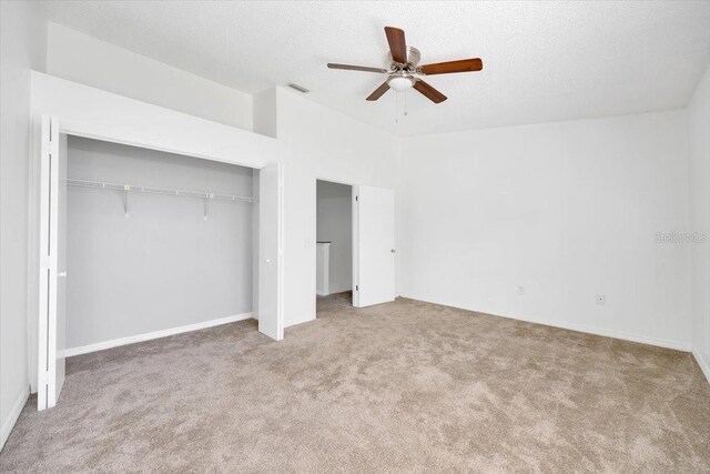 329 Marion Oaks Blvd Unit A3, Ocala, FL 34473 - unfurnished bedroom with carpet flooring, a closet, ceiling fan, and a textured ceiling
