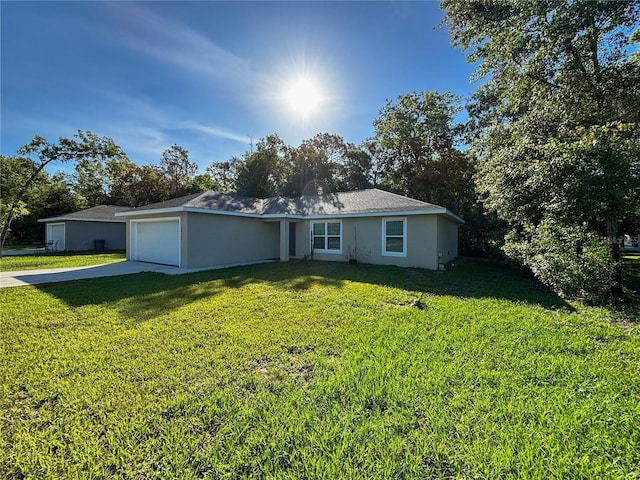 10347 N Halsey Way, Dunnellon, FL 34434 - ranch-style house featuring a front yard, concrete driveway, an attached garage, and stucco siding