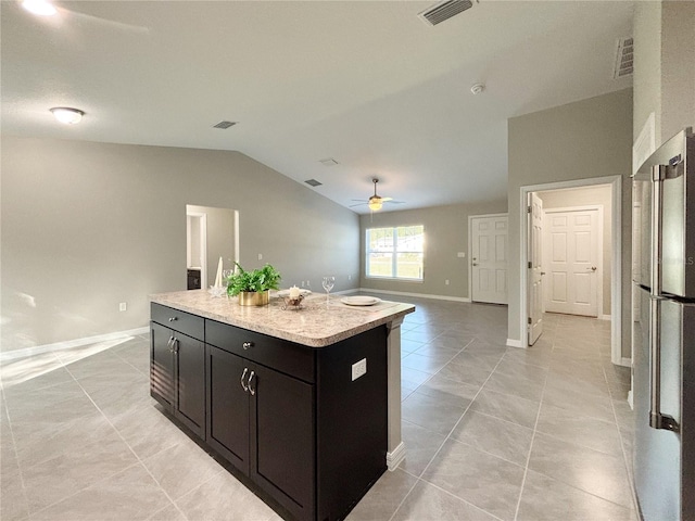 10347 N Halsey Way, Dunnellon, FL 34434 - kitchen featuring freestanding refrigerator, ceiling fan, vaulted ceiling, a kitchen island, and light tile patterned floors