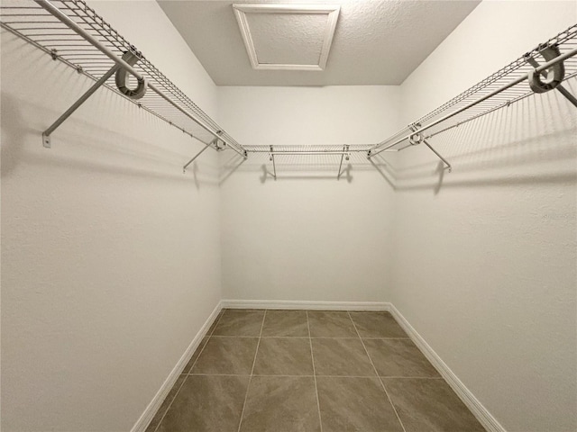 10347 N Halsey Way, Dunnellon, FL 34434 - walk in closet featuring dark tile patterned flooring