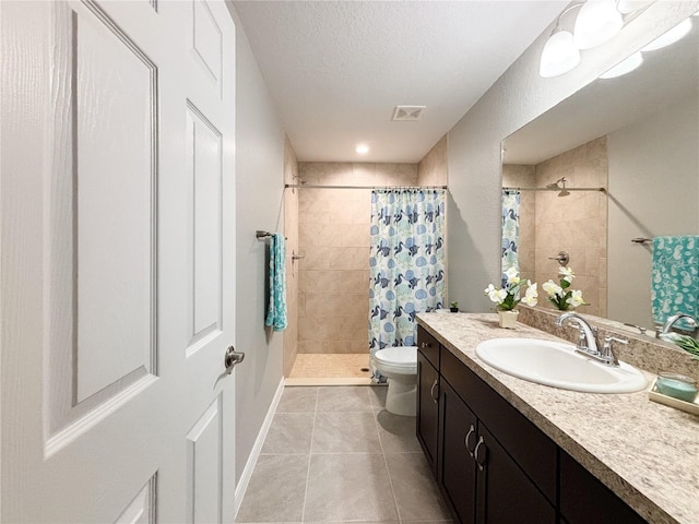 10347 N Halsey Way, Dunnellon, FL 34434 - bathroom featuring tiled shower, vanity, tile patterned flooring, and a textured ceiling