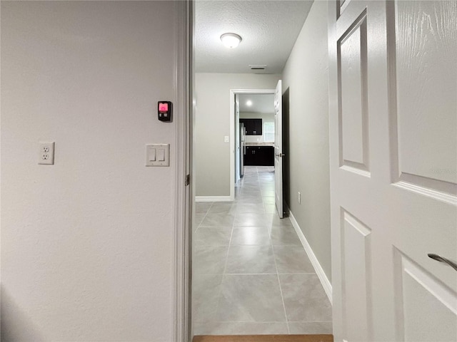 10347 N Halsey Way, Dunnellon, FL 34434 - hallway featuring light tile patterned floors and a textured ceiling