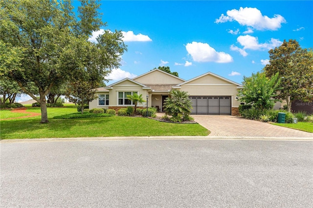 9925 SW 95th Loop, Ocala, FL 34481 - ranch-style house with an attached garage, decorative driveway, a front lawn, and stucco siding