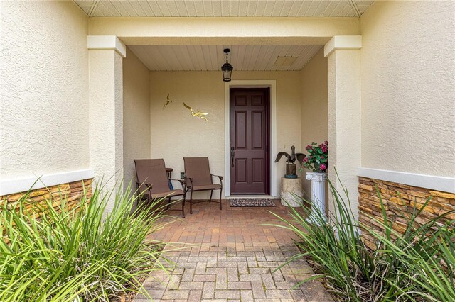 9925 SW 95th Loop, Ocala, FL 34481 - property entrance featuring stucco siding and a porch
