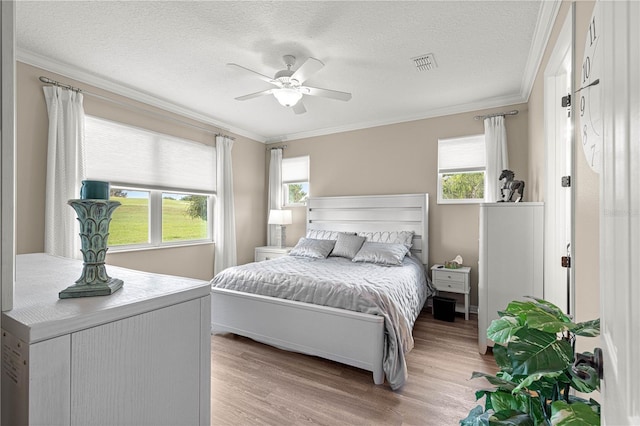 9925 SW 95th Loop, Ocala, FL 34481 - bedroom with ornamental molding, light wood-type flooring, a textured ceiling, and ceiling fan