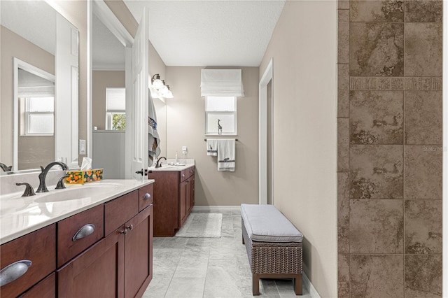 9925 SW 95th Loop, Ocala, FL 34481 - full bathroom featuring two vanities, a tile shower, and a textured ceiling