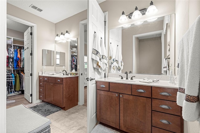 9925 SW 95th Loop, Ocala, FL 34481 - bathroom with a walk in closet and two vanities