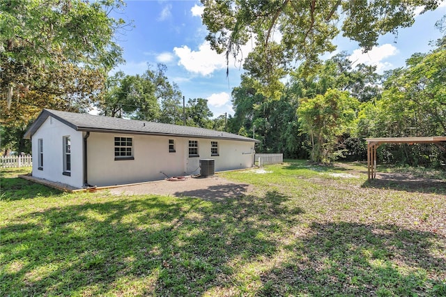 1636 SW 5th Pl, Ocala, FL 34471 - rear view of house featuring stucco siding and view of scattered trees