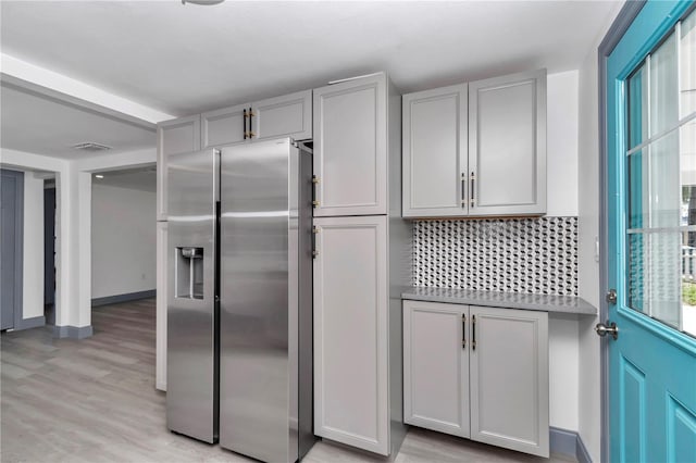 1636 SW 5th Pl, Ocala, FL 34471 - kitchen featuring stainless steel fridge with ice dispenser, light wood-type flooring, tasteful backsplash, and gray cabinets