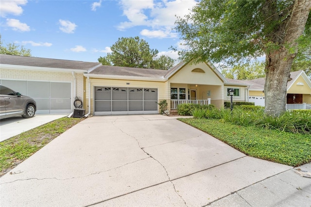 9085 SW 96th Ln Unit B, Ocala, FL 34481 - ranch-style home featuring an attached garage, concrete driveway, covered porch, and brick siding