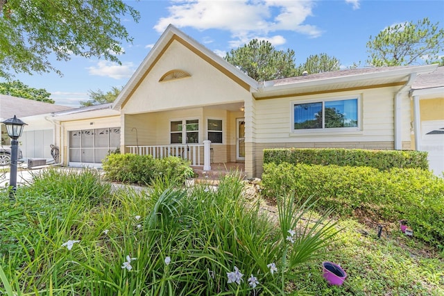 9085 SW 96th Ln Unit B, Ocala, FL 34481 - view of front of house with a garage and a porch