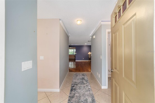 9085 SW 96th Ln Unit B, Ocala, FL 34481 - corridor featuring light tile patterned flooring, a textured ceiling, and ornamental molding