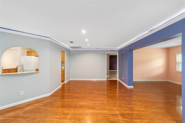 9085 SW 96th Ln Unit B, Ocala, FL 34481 - empty room with light wood finished floors, recessed lighting, and ornamental molding