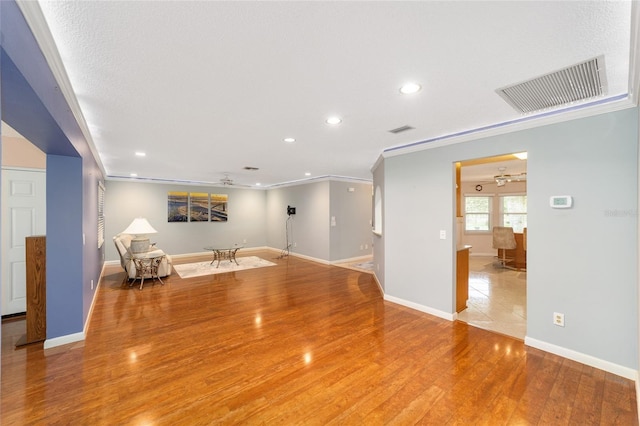 9085 SW 96th Ln Unit B, Ocala, FL 34481 - unfurnished living room with recessed lighting, light wood-style floors, and ornamental molding