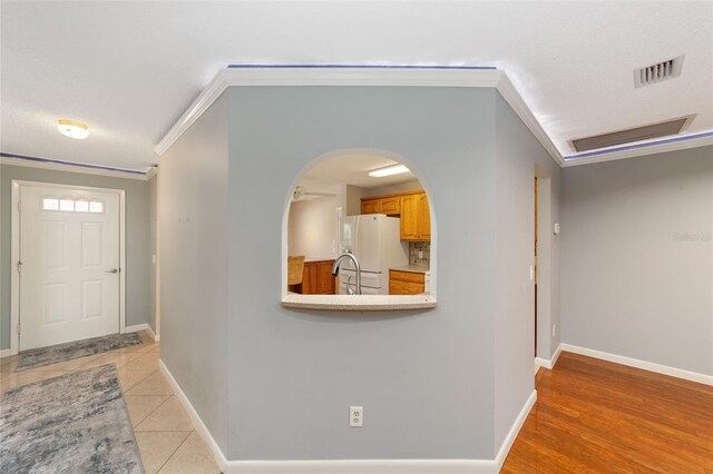 9085 SW 96th Ln Unit B, Ocala, FL 34481 - entryway featuring crown molding, arched walkways, and light tile patterned floors