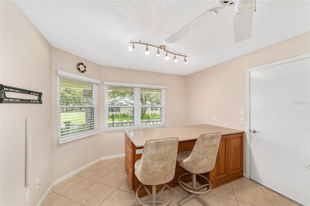 9085 SW 96th Ln Unit B, Ocala, FL 34481 - dining area featuring light tile patterned floors, a ceiling fan, a textured ceiling, a desk, and track lighting