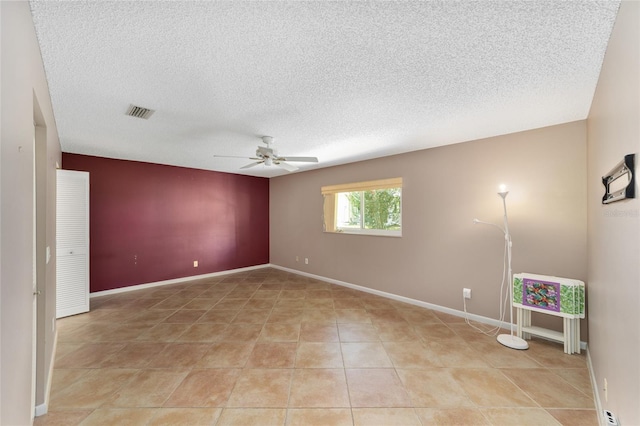 9085 SW 96th Ln Unit B, Ocala, FL 34481 - spare room with a ceiling fan, a textured ceiling, and light tile patterned floors