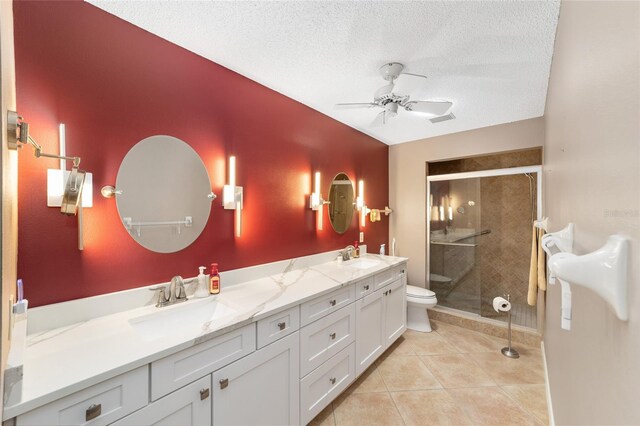 9085 SW 96th Ln Unit B, Ocala, FL 34481 - full bath with a ceiling fan, double vanity, a stall shower, tile patterned flooring, and a textured ceiling