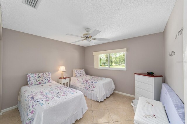 9085 SW 96th Ln Unit B, Ocala, FL 34481 - bedroom featuring a textured ceiling, light tile patterned floors, and a ceiling fan