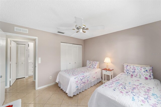 9085 SW 96th Ln Unit B, Ocala, FL 34481 - bedroom with a closet, light tile patterned floors, ceiling fan, and a textured ceiling