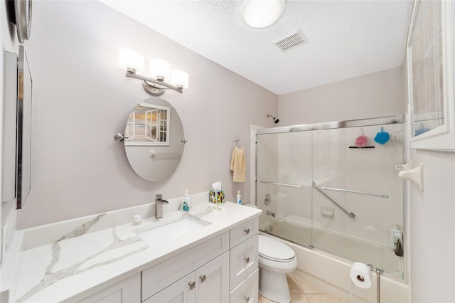 9085 SW 96th Ln Unit B, Ocala, FL 34481 - bathroom with vanity, shower / bath combination with glass door, a textured ceiling, and tile patterned flooring