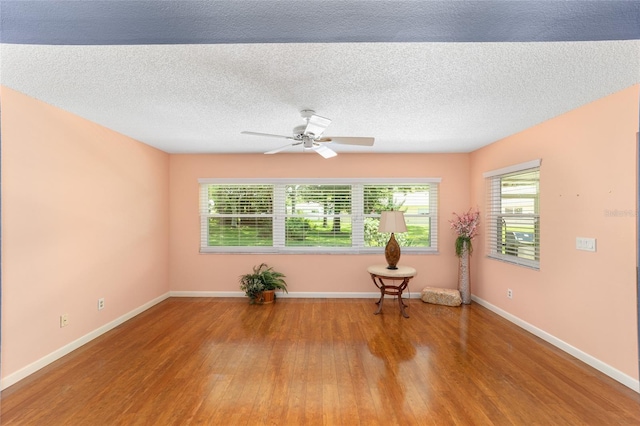 9085 SW 96th Ln Unit B, Ocala, FL 34481 - empty room with wood finished floors, ceiling fan, and a textured ceiling