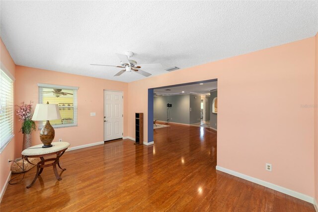 9085 SW 96th Ln Unit B, Ocala, FL 34481 - living room featuring a ceiling fan, wood finished floors, and a textured ceiling